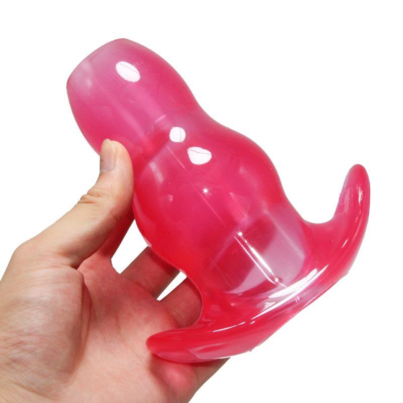 Flexible pink silicone anal plug with tail for adult pleasure, designed for comfort and stimulation.