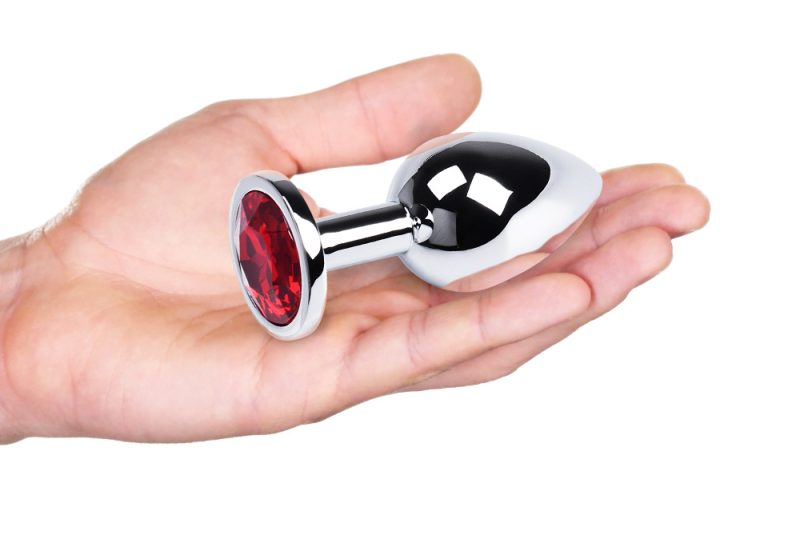 Genuine metal sex toy with red gem accent, luxury adult pleasure accessory for couples and solo use.
