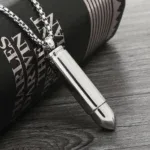 Elegant silver bullet pendant on a chain for stylish jewelry. Perfect accessory for modern fashion a.