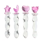 Set of four beaded glass dildos with pink charm handles in different shapes.