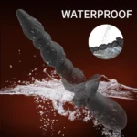 Waterproof black vibrating anal beads with prostate tip in water.
