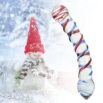 Colorful glass dildo with red, white, and blue swirls on snowy background.